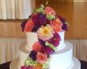 Gorgeously lit and cascading with beautiful roses and hydrangeas in shades of pink and whites, accented with jewels; this cake display steals the spotlight.