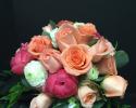 Hot pink Peonies, orange roses and white ranunculus give this bridal bouquet a tropical feel.
